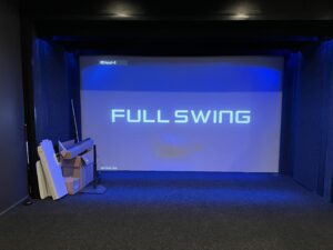 A projector screen with the words " full swing ".